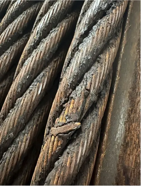 Crown wire breaks and corrosion on a wire rope from a Konecranes quay crane, with a broken outer wire lifting off the strand