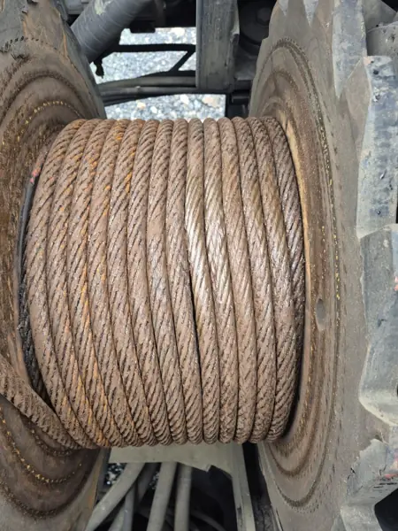 Manitowoc 999 boom hoist rope on the drum coated in excess grease and dirt