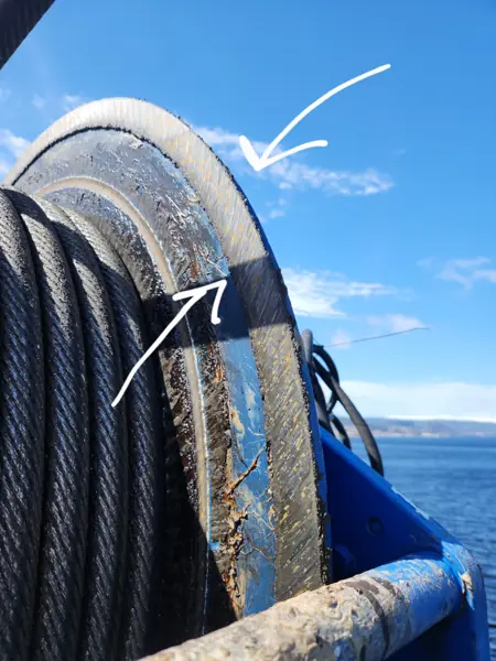 Worn, gouged hoist winch drum flange on a fixed port cargo crane