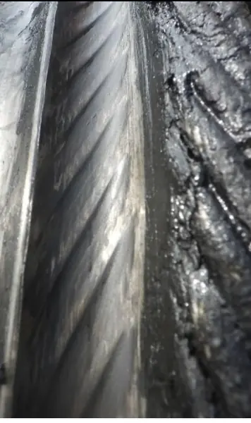 Drum of a port RTG crane with a wrong lay direction rope installed, the rope pattern worn into the drum