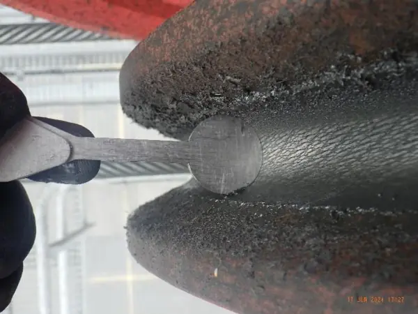 Sheave groove gauge seated in a headblock sheave of a ship-to-shore container crane