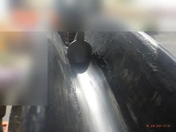 Sheave gauge seated in a spreader sheave groove worn down to the rope's nominal diameter