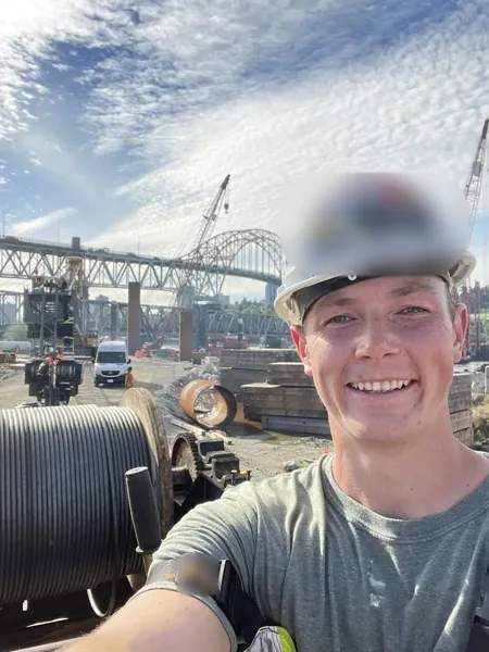 Dean McDonald beside a reel of hoist rope during an installation on a Liebherr LR 1400