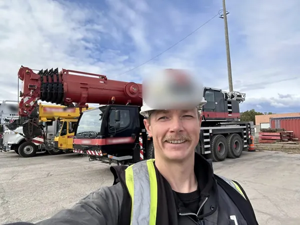 Dean McDonald in front of a Liebherr mobile crane after a sheave groove inspection