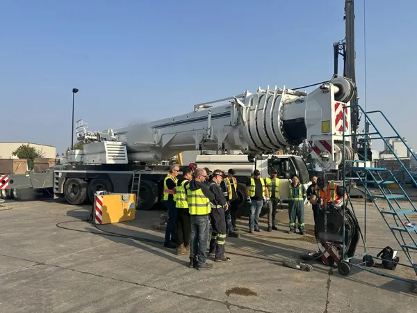 Dean McDonald running wire rope field training for a crane crew beside a Liebherr all-terrain crane