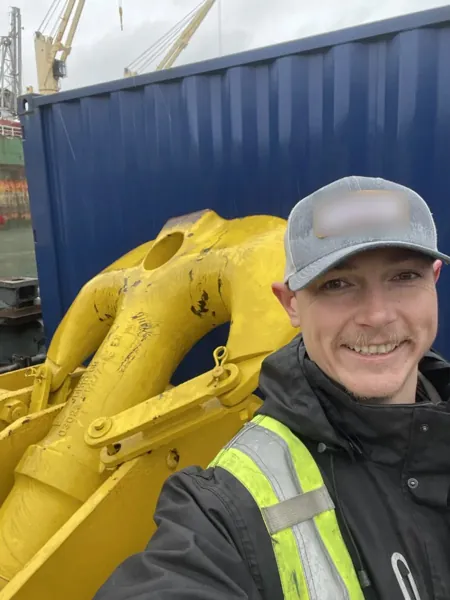 Dean McDonald beside the hook block of a Manitowoc M-1200 Ringer