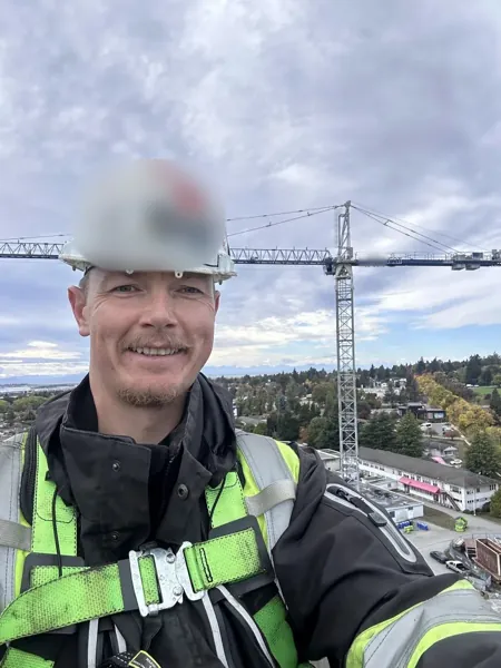 Dean McDonald in a harness on a Jaso J300 tower crane during a hoist rope inspection